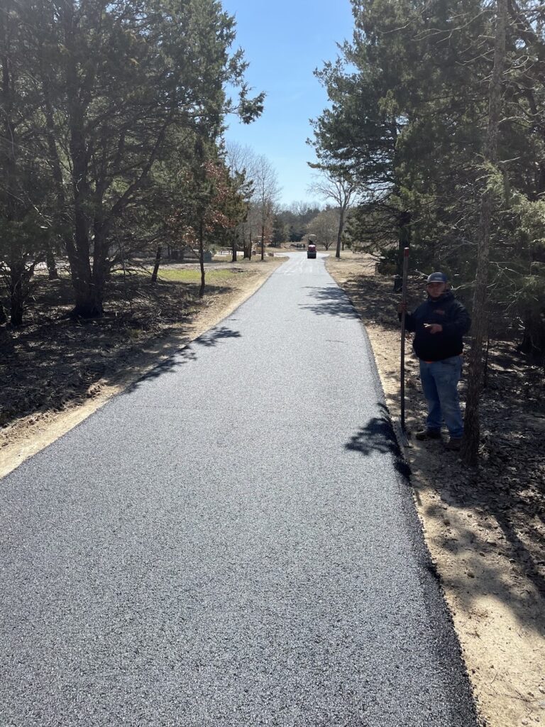 New asphalt driveway through the trees