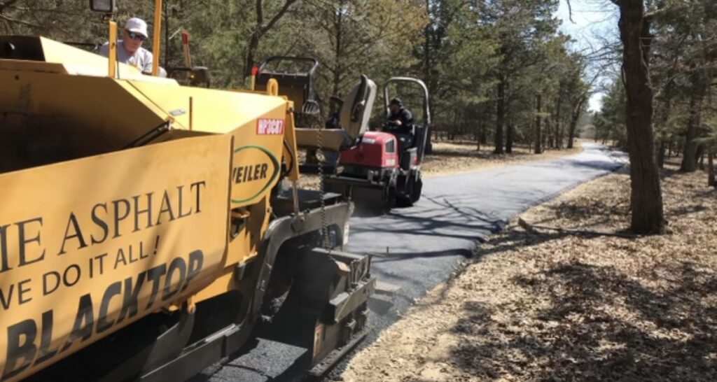 Paver laying a long wooded driveway