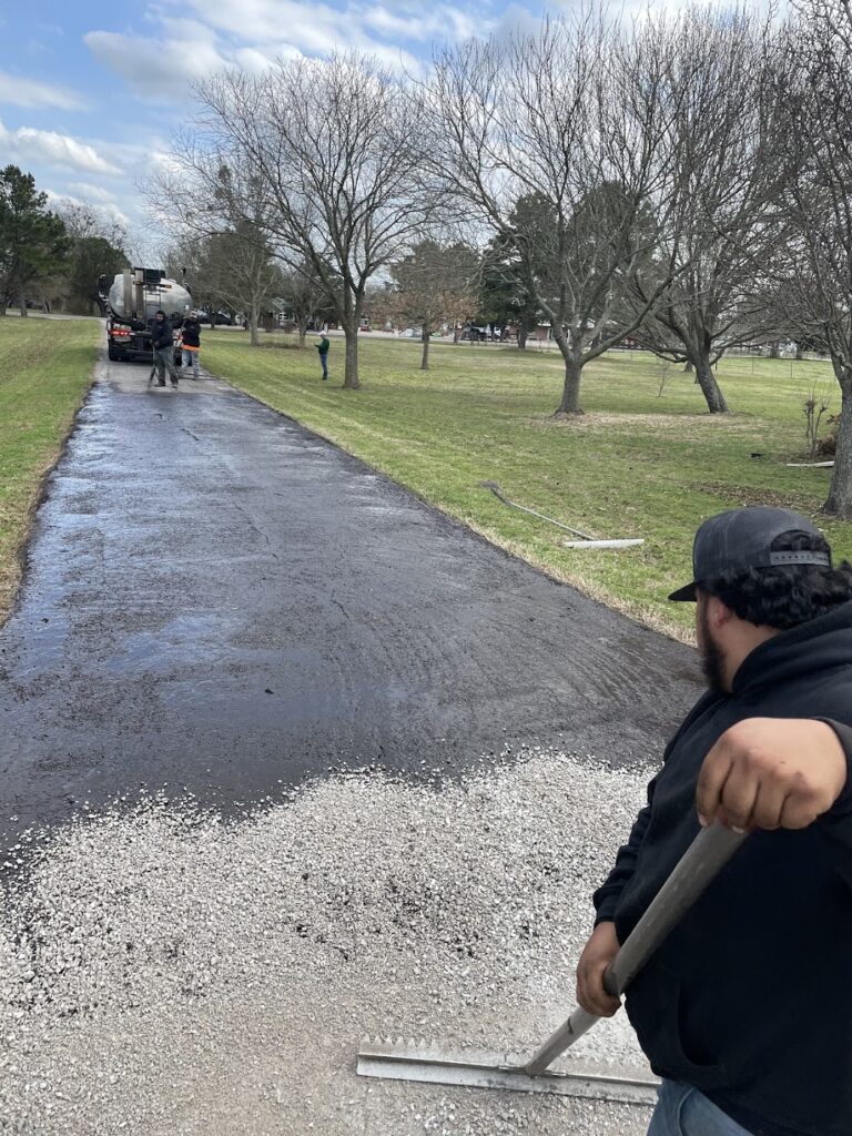 Smoothing the edge of a new asphalt driveway