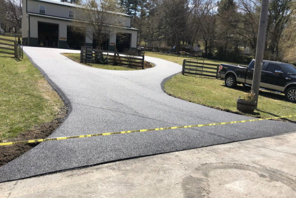 Curved asphalt driveway at a ranch-style home