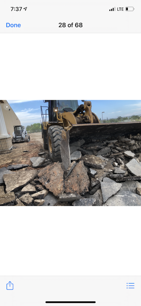 Loader breaking out old asphalt