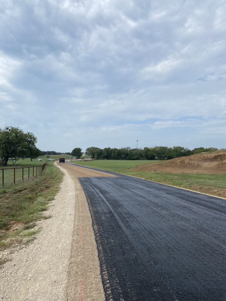 New asphalt road between fields