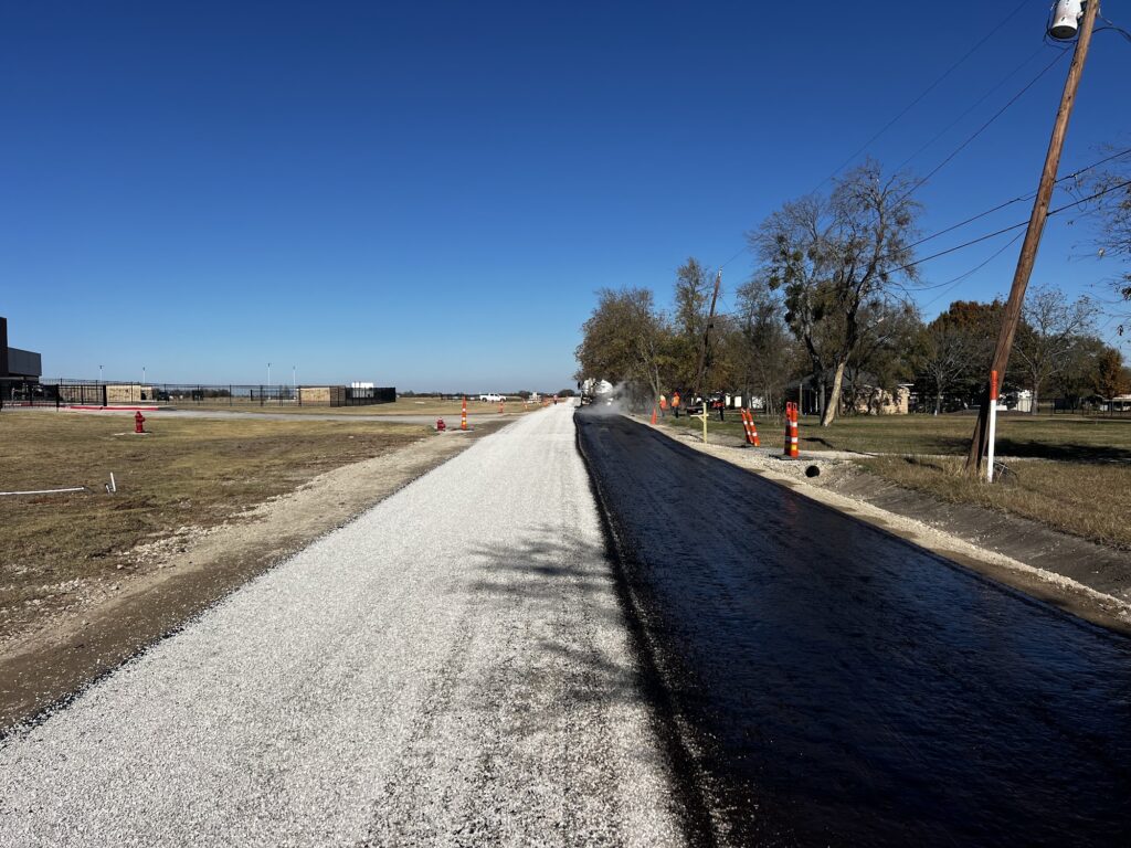 Chip seal road in progress, one lane sealed