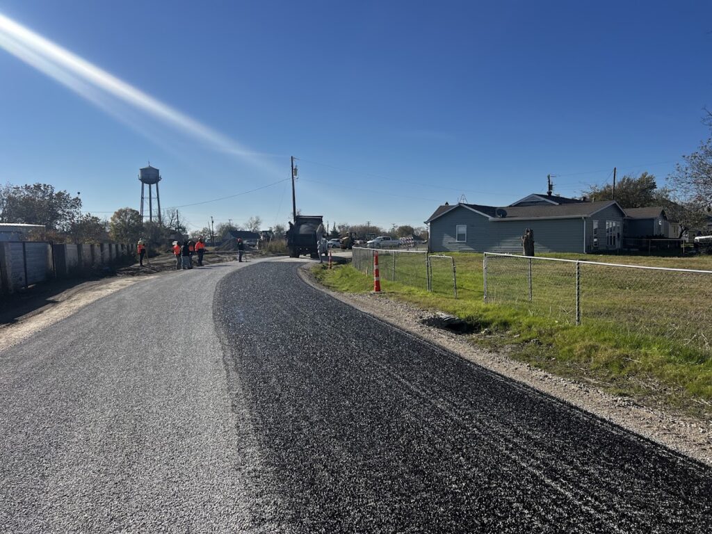 Finished chip seal lane beside the gravel shoulder